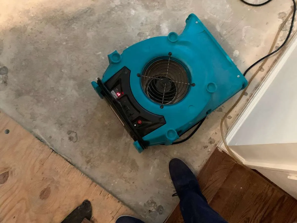 Air mover drying subfloor during Leak Detection & Repair in New Bedford